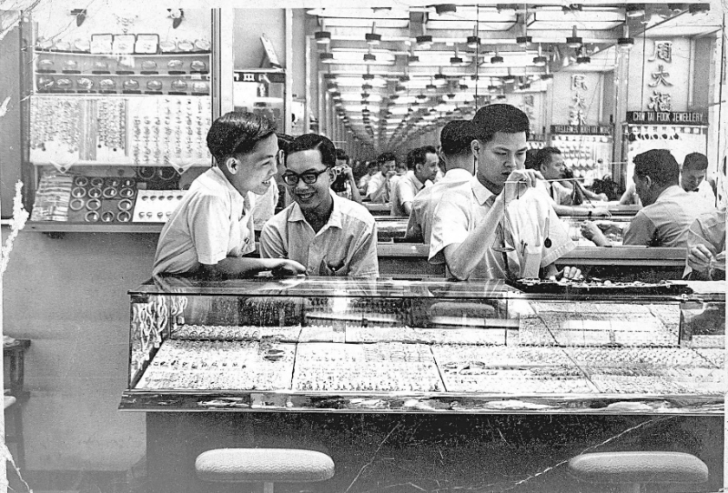 六、七十年代，店員使用厘躉桿秤來秤金。