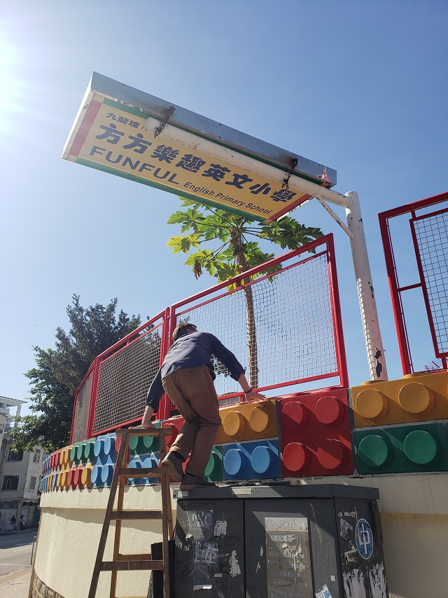 小學(xué)部負(fù)責(zé)人朱先生知悉后，親自爬高嘗試將招牌放下來(lái)，但招牌太重不成功。 陳兆龍攝