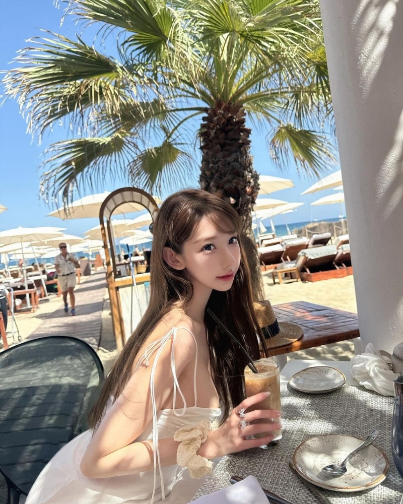 照片中可見Cammi換上多套服裝，分別是一套藍(lán)白條紋的比堅(jiān)尼、白色吊帶連身裙、白色長(zhǎng)袖防曬衣，在沙灘上擺出不同誘人姿勢(shì)。