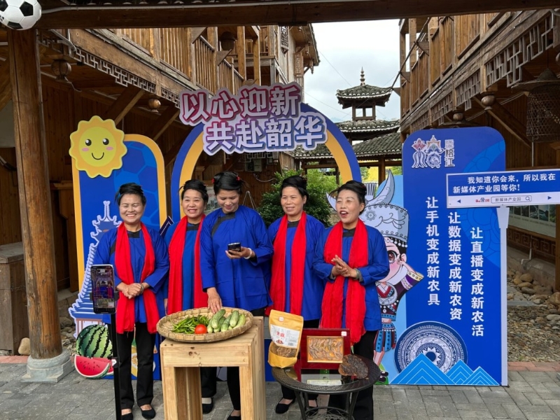 在新媒體產(chǎn)業(yè)園，一群穿著侗族服裝的中年婦女唱著侗歌直播帶貨。